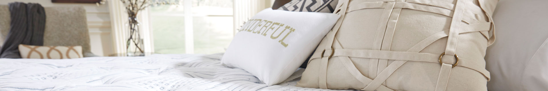 Bed with throw pillow.